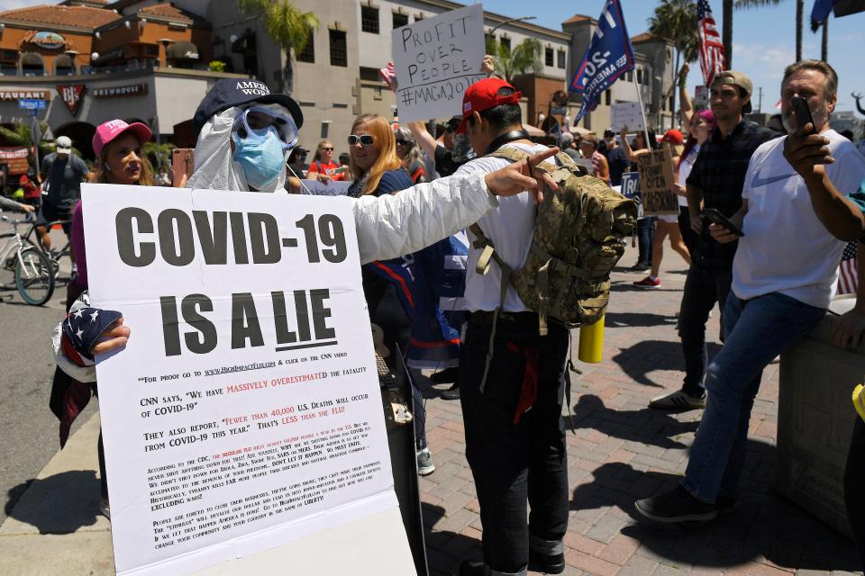 Protesters demonstrate against stay-at-home orders that were put in place due to the COVID-19 outbreak, Friday, April 17, 2020, in Huntington Beach, Calif. (AP Photo/Mark J. Terrill) ORG XMIT: CAMT117