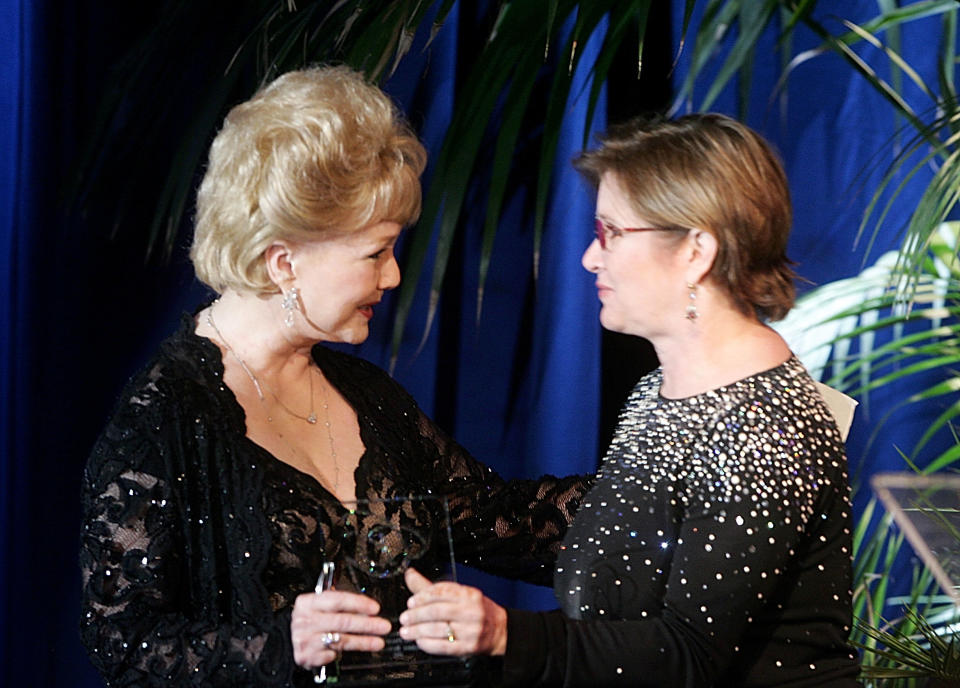 Carrie Fisher gives the Lacoste Presidents Award to her mother at the 2005 Costume Designers Guild Awards at the Beverly Hilton Hotel in Beverly Hills.