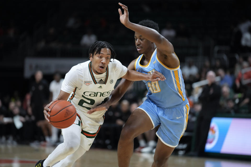 Miami guard Nijel Pack (24) drives past LIU Brooklyn guard RJ Greene (10) during the first half of an NCAA college basketball game in Coral Gables, Fla., Wednesday, Dec. 6, 2023. (AP Photo/Rebecca Blackwell)