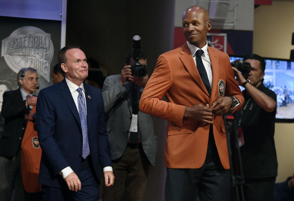 Basketball Hall of Fame inductee Ray Allen, right, smiles after he was presented his Hall of Fame jacket by Naismith Hall of Fame President and CEO John Doleva during a news conference at the Naismith Memorial Basketball Hall of Fame, Thursday, Sept. 6, 2018, in Springfield, Mass. (AP Photo/Jessica Hill)