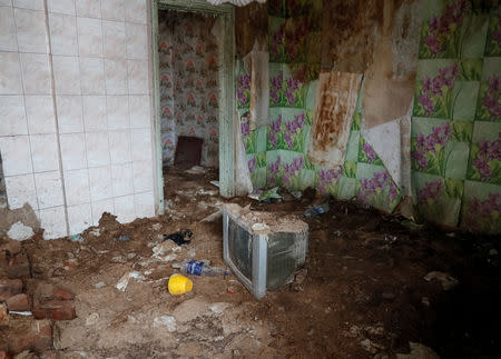 A house damaged by shelling is seen in the village of Zaitseve, Ukraine, February 26, 2019. There are not many people left in Zaitseve, a village on the front line that divides Ukraine between government-controlled territory and the enclave controlled by Russian-backed separatist forces. Troops are stationed in trenches outside Zaitseve and government trucks risk rebel fire to bring bread, coal, firewood and other goods along a dirt road. REUTERS/Gleb Garanich