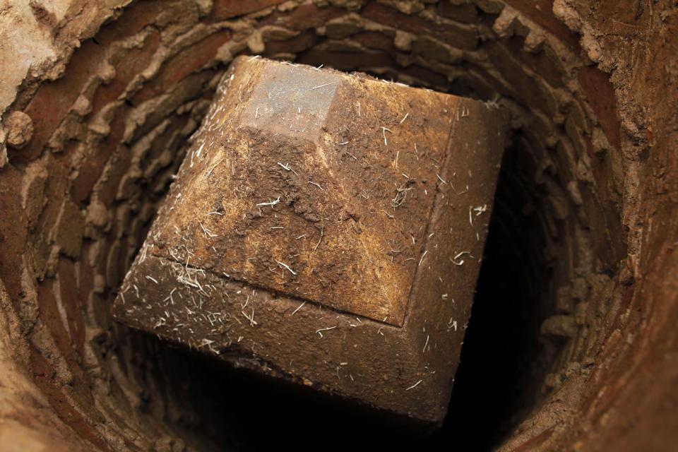 A smaller obelisk in a well 12-feet deep which was used as a geodetic marker and referred to as "the mini monument", is seen at the base of the Washington Monument in Washington, Tuesday, March 13, 2012. Government surveyors are collecting data around the Washington Monument and other sites on the National Mall that will reveal whether it has sunk or tilted since last yearís earthquake. (AP Photo/Charles Dharapak)