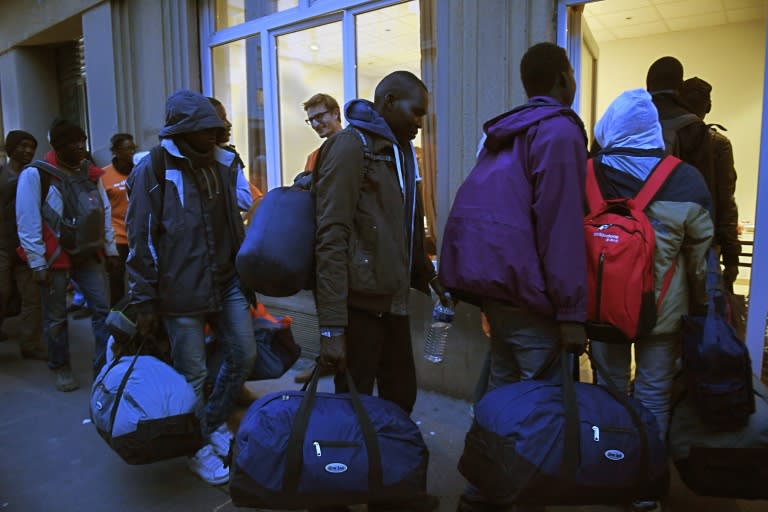 Migrants arrive by bus from the "Jungle" on October 24, 2016 to a shelter in Lyon, southeastern France