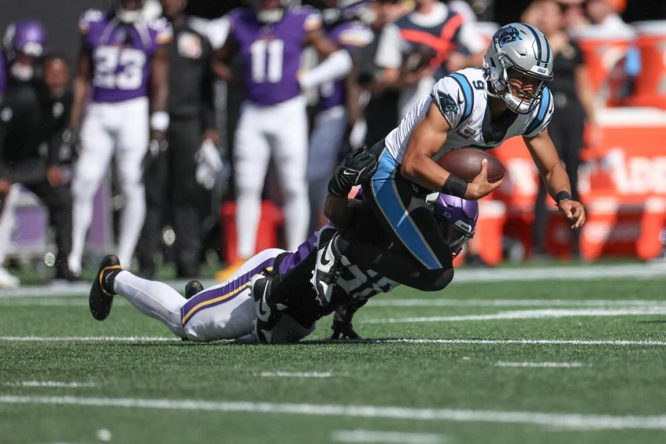 Panthers quarterback Bryce Young, right, is brought down during a keeper by Minnesota linebacker Jordan Hicks during the game at Bank of America Stadium on Sunday, October 1, 2023 in Charlotte, NC.