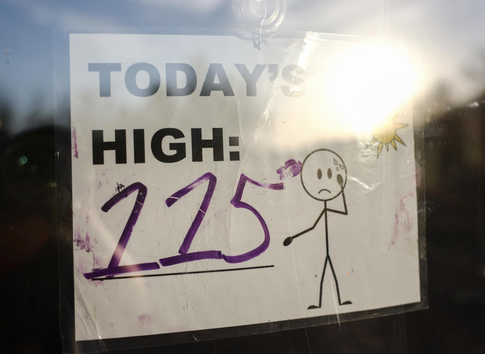 A sign in a window that says "Today's high: 115"