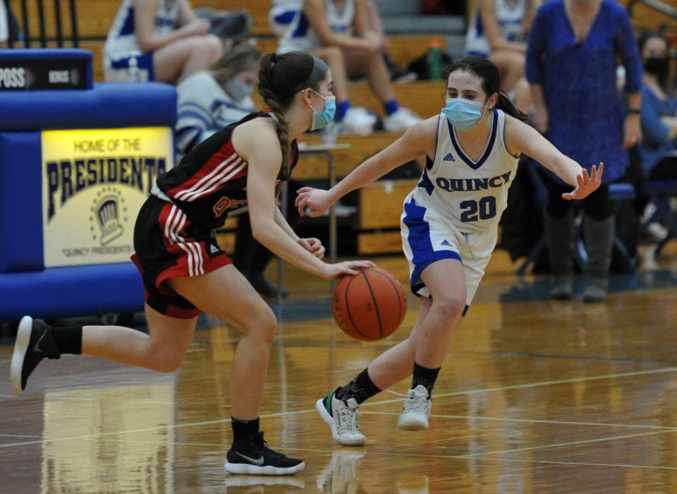 North Quincy's Kiera Sleiman, left, drives against Quincy's Mary Saccoach during girls basketball action at Quincy High School on Tuesday, Jan. 19, 2021.