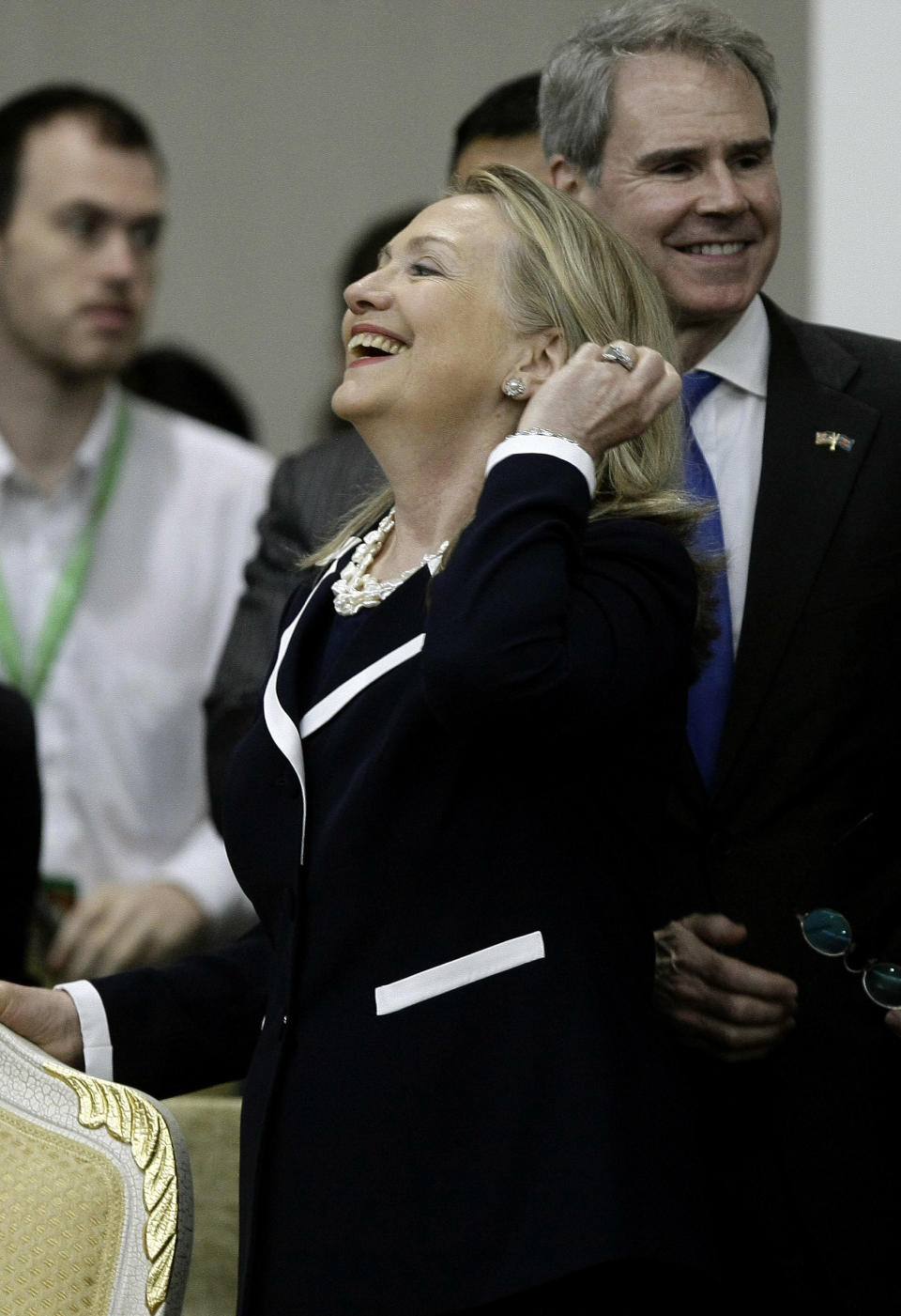 U.S. Secretary of State Hillary Rodham Clinton, center, laughs before taking her seat during the 2nd East Asia Summit (EAS) Foreign Ministers' Meeting in Phnom Penh, Cambodia, Thursday, July 12, 2012. (AP Photo/Heng Sinith)