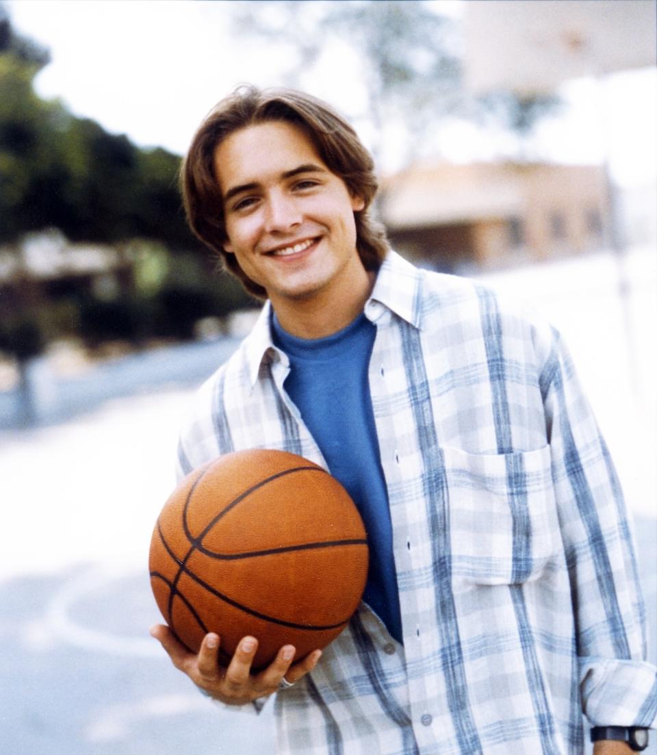 Will holds a basketball while smiling