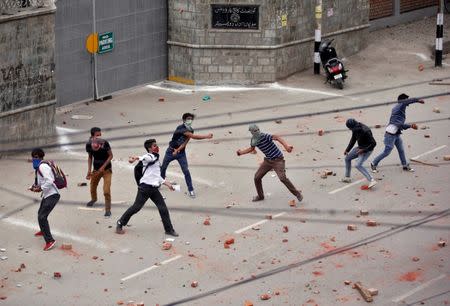 Demonstrators throw stones towards the Indian police during a protest in Srinagar, May 9, 2017. REUTERS/Danish Ismail