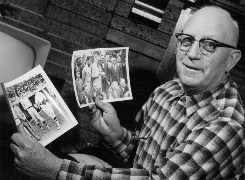 George Mogridge proudly shows photos from his days playing for the New York Yankees and the Washington Senators in this undated photo from the Democrat and Chronicle archives.