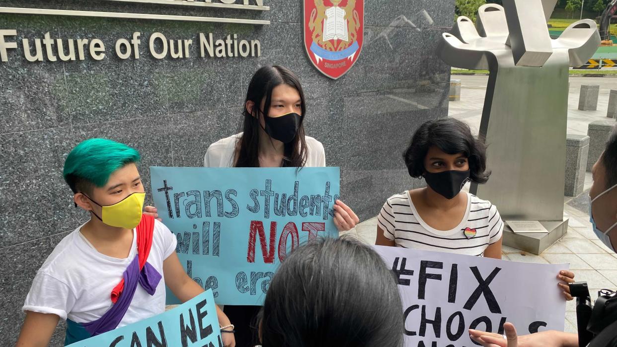 (From left) Elijah Tay, Lune Loh and Kokila Annamalai seen protesting outside the Ministry of Education headquarters at Buona Vista on Tuesday (26 January) afternoon. (PHOTO: Dhany Osman/Yahoo News Singapore)