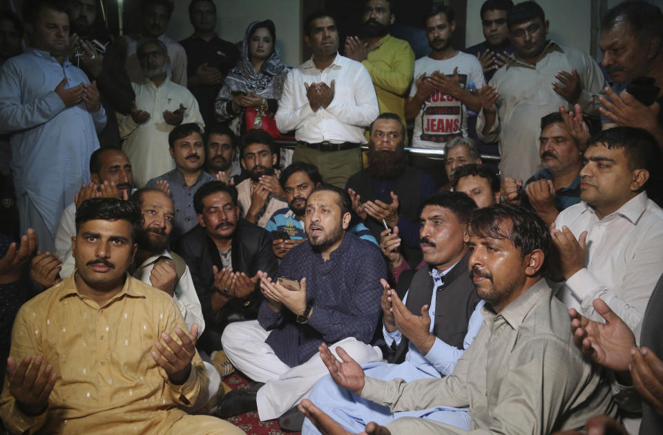 Supporters of Pakistan's former Prime Minister Nawaz Sharif pray for health of their leader outside a hospital where Sharif is admitted, in Lahore, Pakistan, Saturday, Oct. 26, 2019. An Islamabad court in an emergency hearing Saturday temporarily set free Pakistan's ailing former prime minister, Nawaz Sharif, who was in prison on money-laundering and corruption convictions. (AP Photo/K.M. Chaudary)