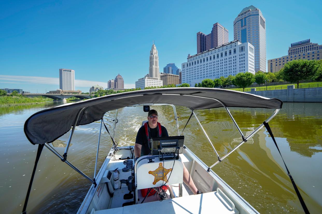 Franklin County Sheriff's office Deputy Stephen Withrow,  who heads the sheriff's dive team, leads media on a tour Wednesday of the Scioto River where they will be patrolling during Red, White and Boom on Friday to keep boaters safe and the waterway behind COSI clear during the fireworks launch.