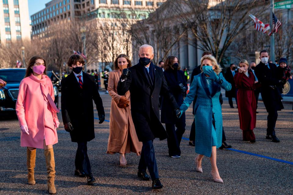 President Joe Biden and first lady Jill Biden walk along Pennsylvania Avenue in front of the White House during Inaugural celebrations, on January 20, 2021, with family members after Biden was sworn in as the 46th president of the United States.