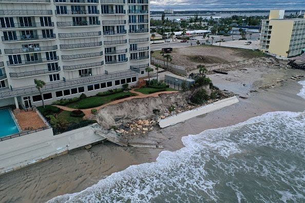 In this aerial view, seawalls along condo buildings are shown breached by Hurricane Nicole on November 10, 2022, in Daytona Beach, Florida. The storm surge associated with Nicole coincided with already-high tides caused by this week's full moon, putting more stress on aging sea walls meant to protect coastal communities.