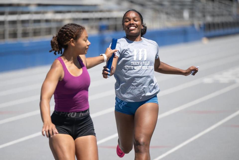 Relay sprinters Josalynn Ragland, right, and Camila Stephens practice baton exchange during a workout at Modesto Junior College in Modesto, Calif., Tuesday, May 14, 2024.