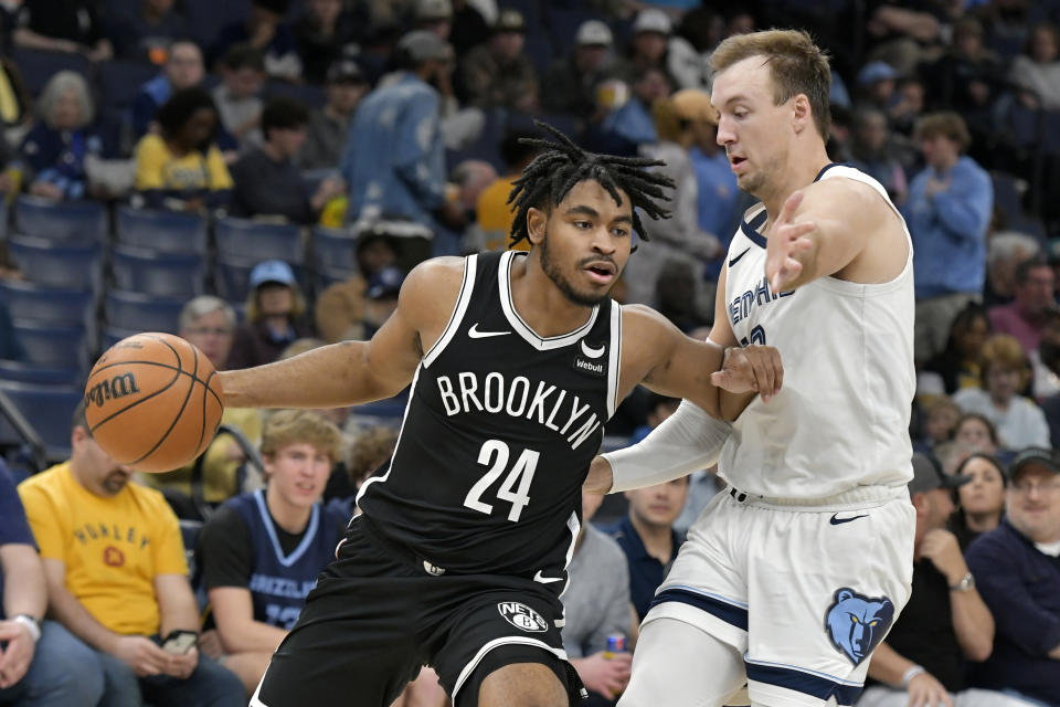 Brooklyn Nets guard Cam Thomas (24) handles the ball against Memphis Grizzlies guard Luke Kennard in the first half of an NBA basketball game Monday, Feb. 26, 2024, in Memphis, Tenn. (AP Photo/Brandon Dill)