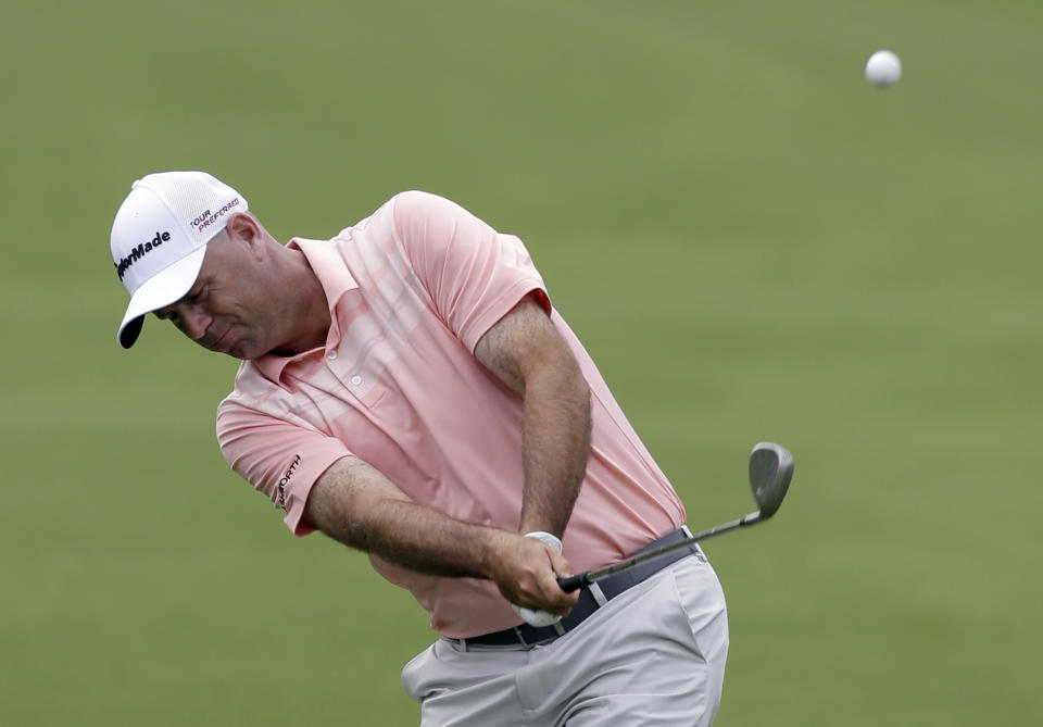 Stewart Cink hits his approach shot on the 18th hole during the first round of the Wells Fargo Championship golf tournament in Charlotte, N.C., Thursday, May 1, 2014. (AP Photo/Bob Leverone)