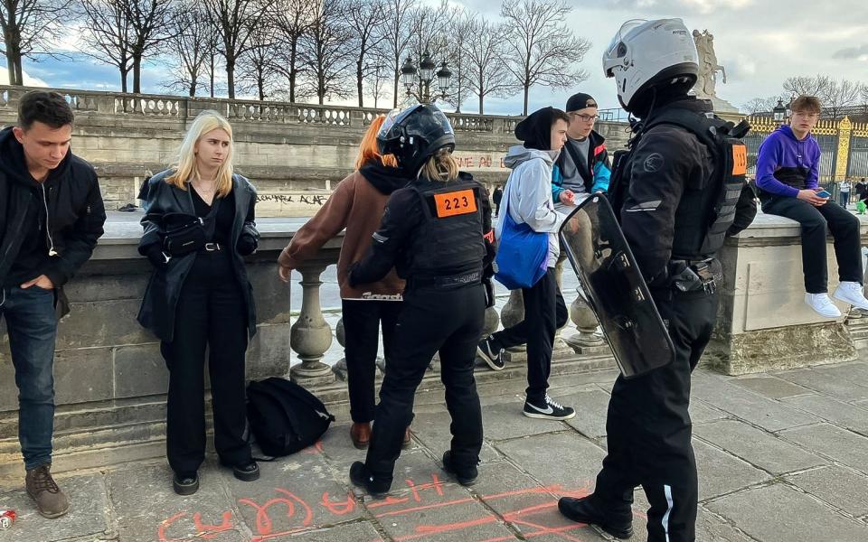 Police officers search protesters after a ban on gatherings or protests on Concorde Square in Paris - Nicolas Garriga/AP