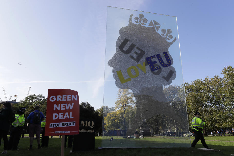 A large perspex banner with a silhouette of Queen Elizabeth and text reading "LovEU" is erected in Hyde Park in London, Saturday, Oct. 19, 2019. Britain's Parliament is set to vote in a rare Saturday sitting on Prime Minister Boris Johnson's new deal with the European Union, a decisive moment in the prolonged bid to end the Brexit stalemate. Various scenarios may be put in motion by the vote. (AP Photo/Kirsty Wigglesworth)