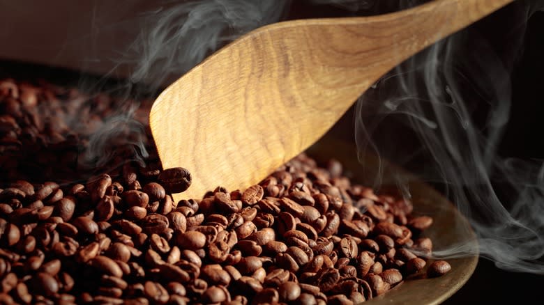 Roasted coffee beans and wooden spoon