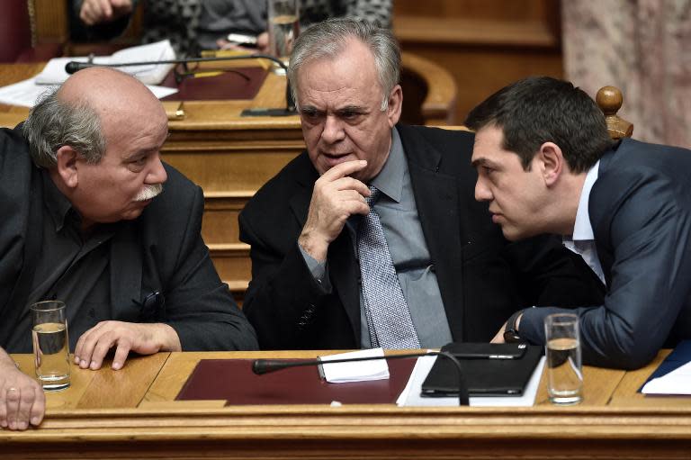 (From R) Greek Prime Minister Alexis Tsipras, Deputy PM Yannis Dragasakis and Interior Minister Nikos Voutsis have a discussion during a parliament session in Athens, in March 2015