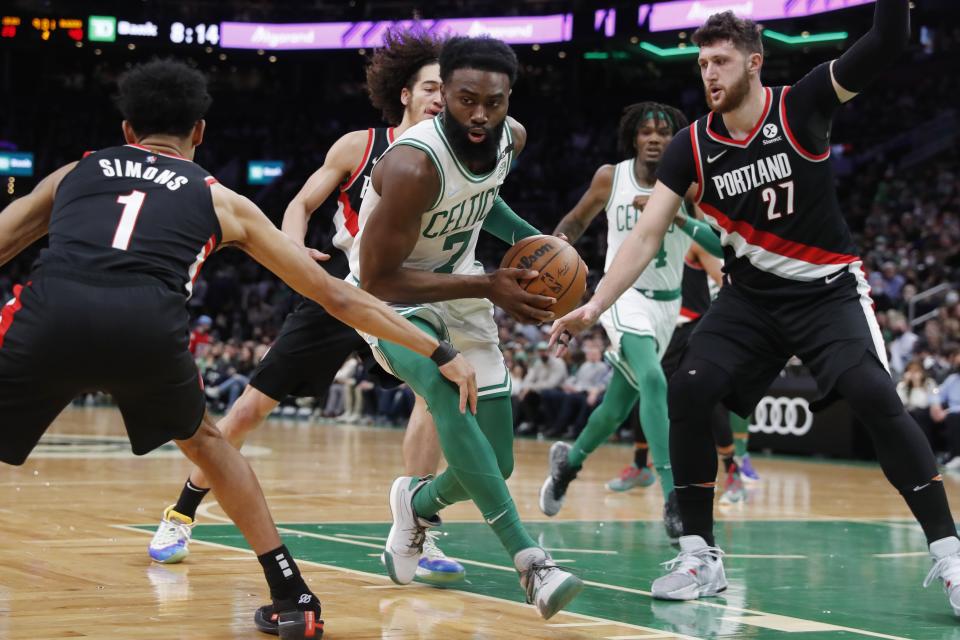 Portland Trail Blazers' Anfernee Simons (1) and Jusuf Nurkic (27) defend against Boston Celtics' Jaylen Brown (7) during the first half of an NBA basketball game Friday, Jan. 21, 2022, in Boston. (AP Photo/Michael Dwyer)