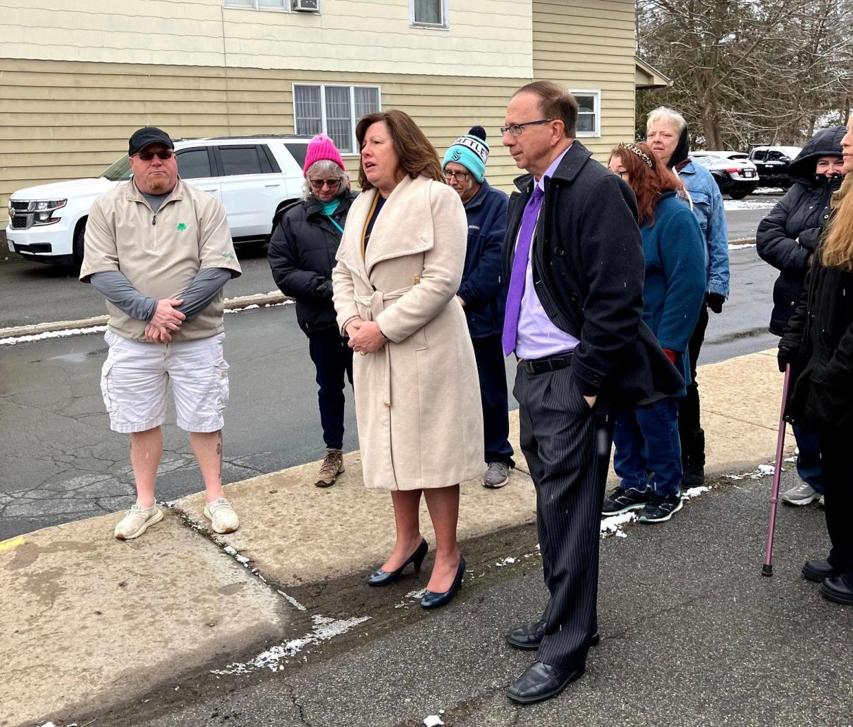 Assemblywoman Marianne Buttenschon, D-Marcy, center, and state Sen. Joseph Griffo, R-Rome, right, stand with residents of the Mary D. Buck Memorial Apartments in Whitesboro on Monday, March 19, 2024. The legislators announced a bill they plan to introduce to require out-of-state owners of multi-unit rental properties that accept public funds to place money in escrow toward utility and tax bills.