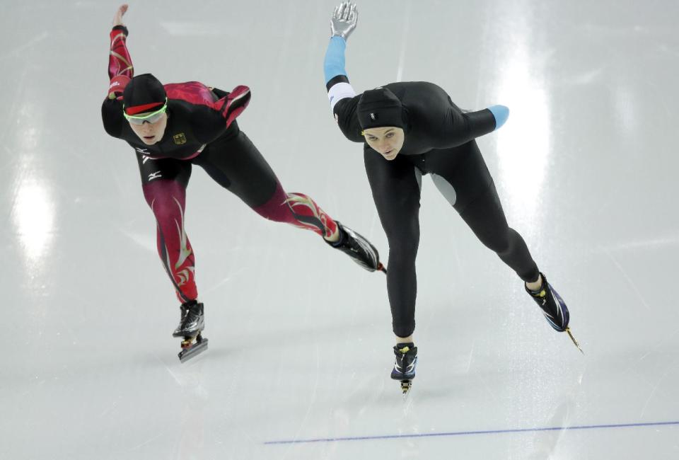 Monique Angermueller of Germany, left, and Heather Richardson of the U.S. compete in the women's 1,500-meter speedskating race at the Adler Arena Skating Center during the 2014 Winter Olympics in Sochi, Russia, Sunday, Feb. 16, 2014. (AP Photo/David J. Phillip )