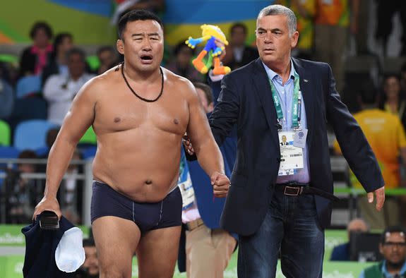 Mongolia's Mandakhnaran Ganzorig's coach reacts after the judges announced that Uzbekistan's Ikhtiyor Navruzov won following a video replay in their men's 65kg freestyle bronze medal match on August 21, 2016, during the wrestling event of the Rio 2016 Olympic Games at the Carioca Arena 2 in Rio de Janeiro. / AFP / Toshifumi KITAMURA        (Photo credit should read TOSHIFUMI KITAMURA/AFP/Getty Images)