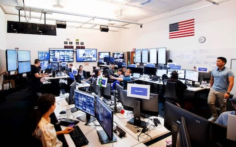 Employees work in Facebook's "War Room," during a media demonstration on October 17, 2018, in Menlo Park, California. - The freshly launched unit at Facebook's Menlo Park headquarters is the nerve center for the fight against misinformation and manipulation of the largest social network by foreign actors trying to influence elections in the United States and elsewhere. The war room, which will ramp up activity for the November 6 midterm US elections, is the most concrete sign of Facebook's efforts to weed out misinformation - Credit: Noah Berger/AFP