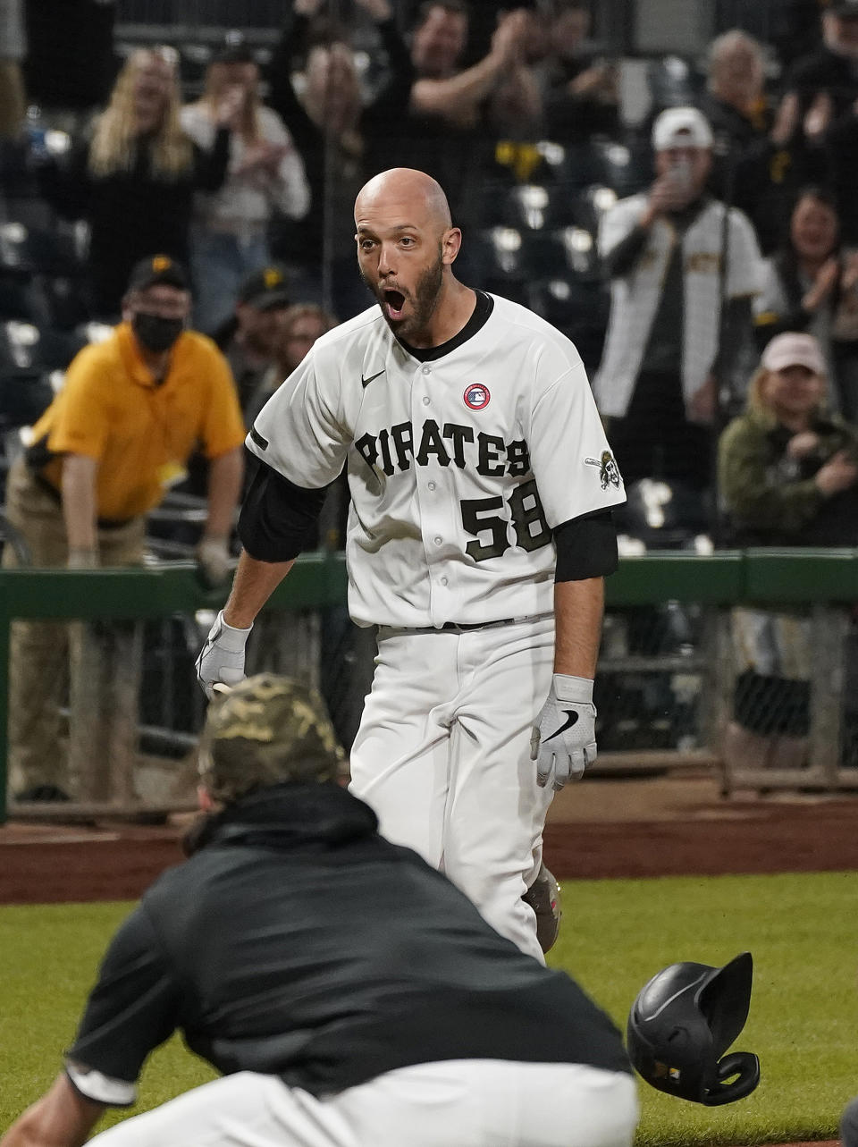 Pittsburgh Pirates catcher Jacob Stallings is mobbed by teammates after hitting a two-run home run against the San Francisco Giants in the ninth inning of a baseball game Saturday May 15, 2021, in Pittsburgh. (Peter Diana/Pittsburgh Post-Gazette via AP)