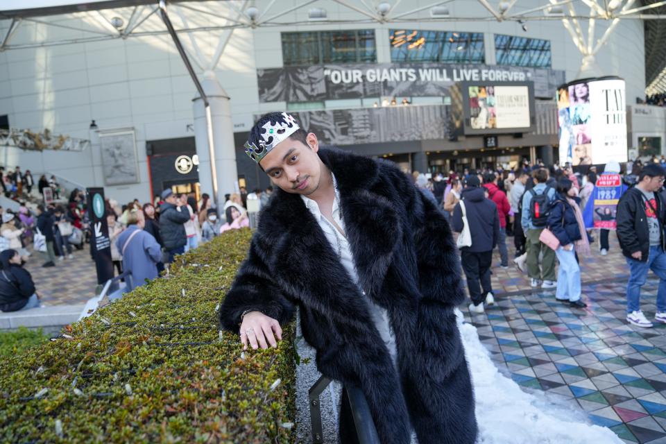 Swiftie influencer Andi Fachrul poses in a black "Reputation"-inspired outfit outside of the Tokyo Dome on Wednesday, Feb. 7, 2024, ahead of Taylor Swift's concert there.