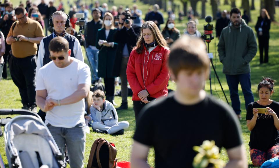 Members of the public observe a minute's silence on the Long Walk in Windsor on April 17, 2021 to mark the start of the funeral service of Britain's Prince Philip, Duke of Edinburgh. - Philip, who was married to Queen Elizabeth II for 73 years, died on April 9 aged 99 just weeks after a month-long stay in hospital for treatment to a heart condition and an infection. (Photo by Tolga Akmen / AFP) (Photo by TOLGA AKMEN/AFP via Getty Images)