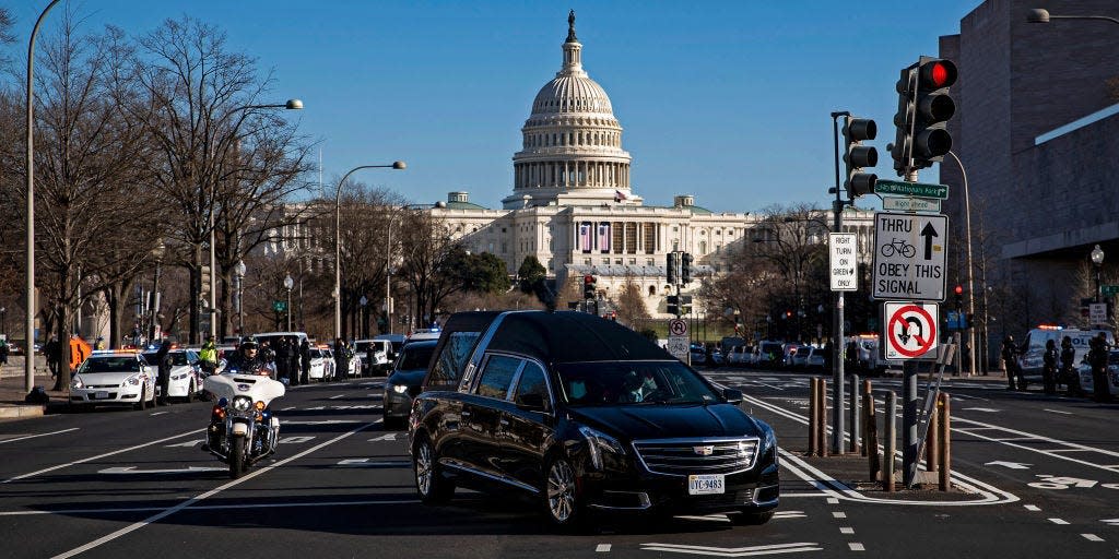 A hearse carrying the casket of Brian Sicknick, U.S. Capitol Police Officer who died from injuries following the U.S. Capitol building siege on Wednesday, turns onto Constitution Avenue during a police procession, on January 10, 2021 in Washington, DC.