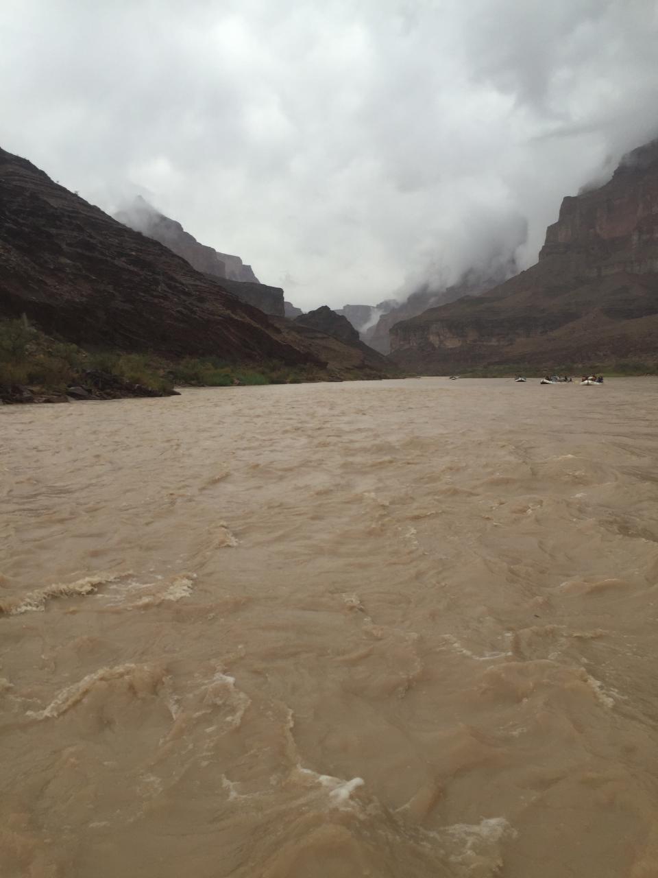 The Colorado River meanders through the Grand Canyon on a cold, rainy day.