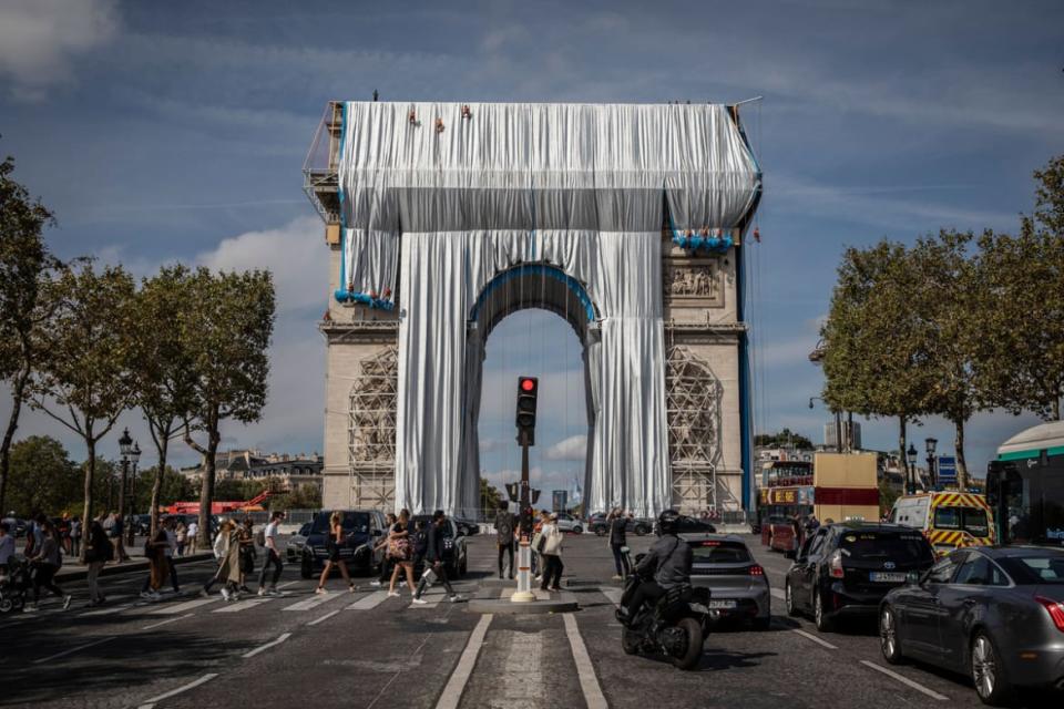 <div class="inline-image__caption"><p>Workers begin the process of wrapping up the Arc De Triomphe monument in silver-blue fabric on September 12, 2021.</p></div> <div class="inline-image__credit">Siegfried Modola/Getty</div>