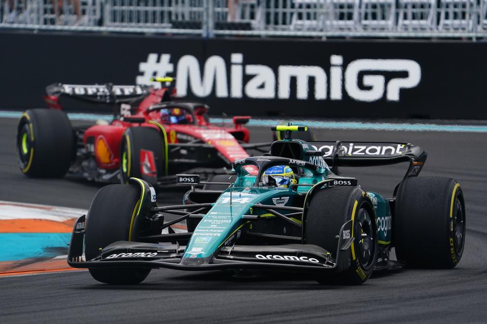 Aston Martin driver Fernando Alonso (14) of Spain leads Ferrari driver Carlos Sainz (55) of Spain during the Miami Grand Prix at Miami International Autodrome.