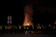 "Yellow vest" protesters stand around a fire in Virsac, near Bordeaux, southwestern France, on Sunday night