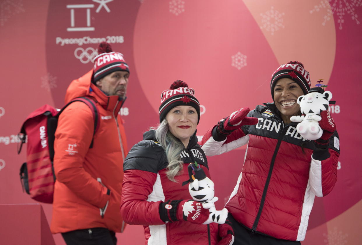 Kaillie Humphries (center), while representing Team Canada, celebrates a bronze medal following women's bobsled event during the Pyeongchang 2018 Winter Olympic Games in South Korea, Feb. 21, 2018. (Jonathan Hayward/The Canadian Press via AP)