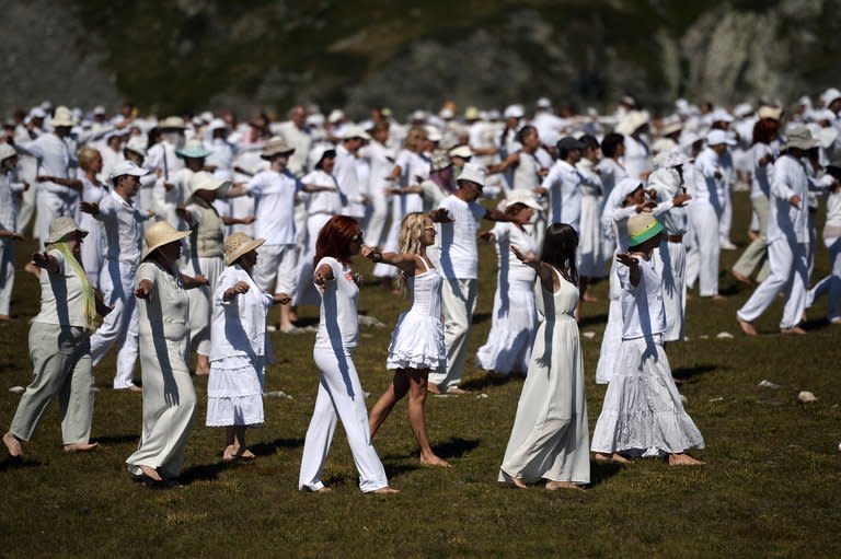 Members of an international religious movement called the White Brotherhood perform ritual dances on top of the Rila Mountain, near Babreka lake, on August 19, 2013. The teaching of the movement, whose founder is Bulgarian Peter Deunov, combines aspects of Christianity and Hinduism with a heavy emphasis on brotherly love, a healthy diet and living in harmony with nature