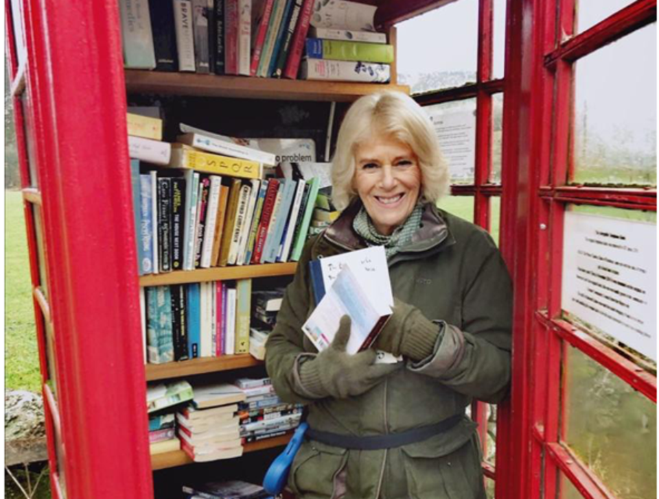 The Duchess of Cornwall depositing books in her local Scottish phone box library.