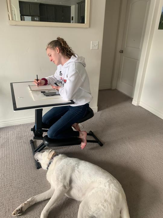 Caitlyn Wilcox, age 14, using the family's new Edge Desk to do school work at home in Heber City, Utah.