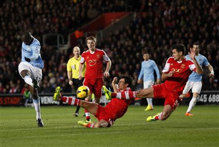 Manchester City's Yaya Toure (L) takes a shot on goal during their English Premier League soccer match against Southampton at St Mary's stadium in Southampton, southern England December 7, 2013. REUTERS/Stefan Wermuth