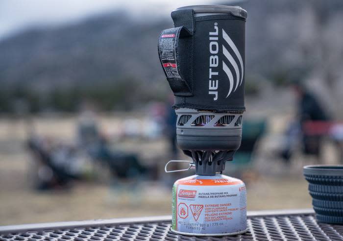 a jetboil stove system on a table at a campsite