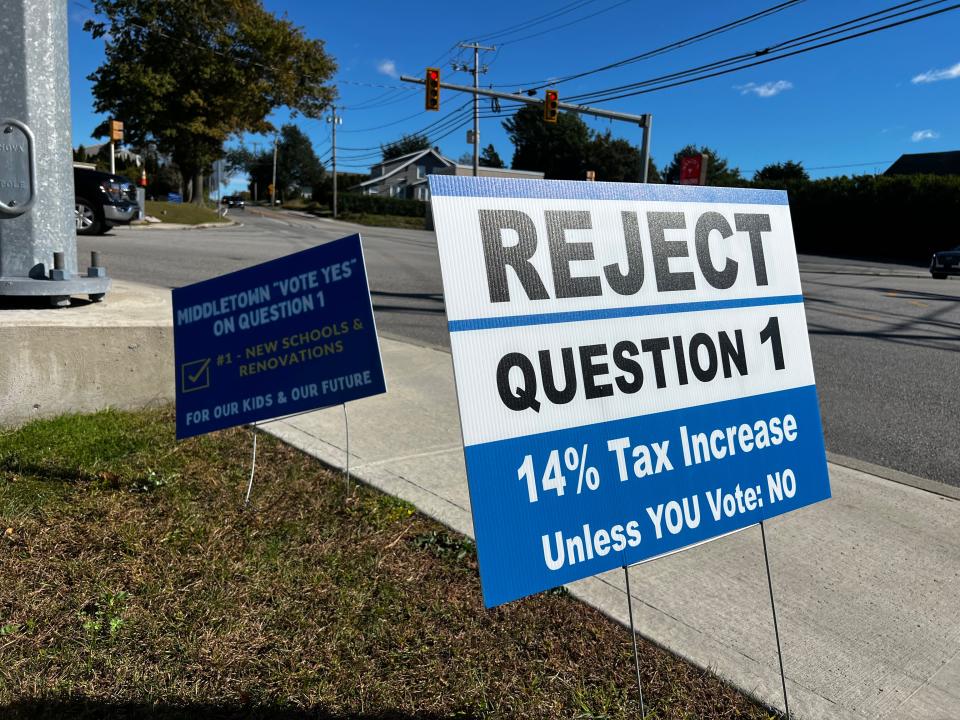 Signs promoting the approval and rejection of a proposed $190 million bond in Middletown battle for attention at the intersection of Aquidneck and Green End avenues.
