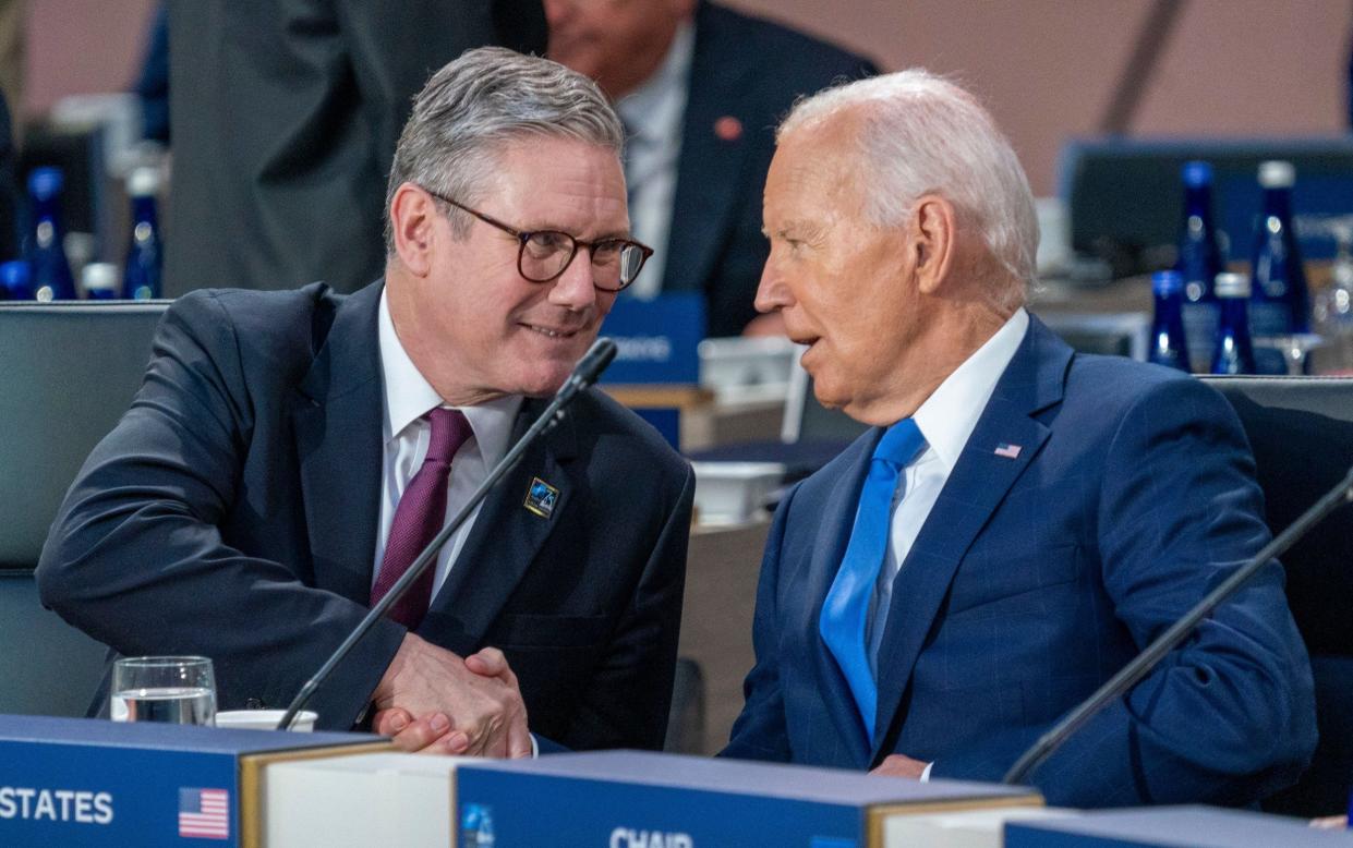 US President Joe Biden (R) and British Prime Minister Keir Starmer (L) participate in the North Atlantic Council meeting with Indo-Pacific partners during the North Atlantic Treaty Organization (NATO) Summit