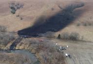 Investigators, cleanup crews begin scouring oil pipeline spill in Kansas