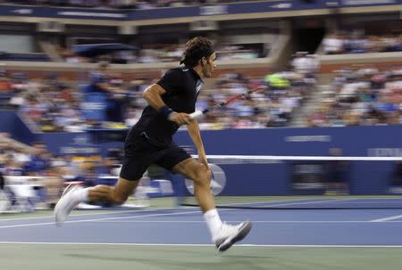 Roger Federer of Switzerland chases down a ball as he plays against Marinko Matosevic of Australia during their first round men's single match at the U.S. Open tennis tournament in New York, August 26, 2014. REUTERS/Shannon Stapleton