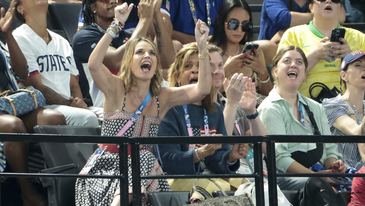 Savannah Guthrie and Hoda Kotb cheering at the women's gymnastics team final. 